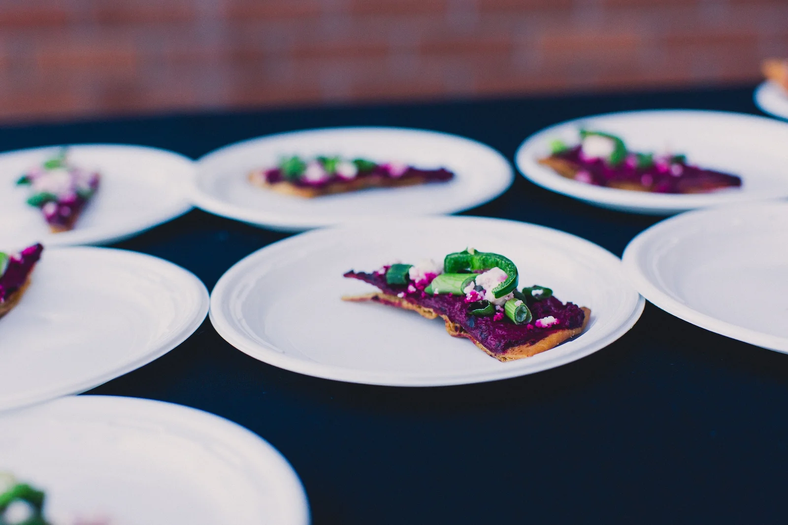 Mediterranean canapés with beet spread and garnishes at wedding catering