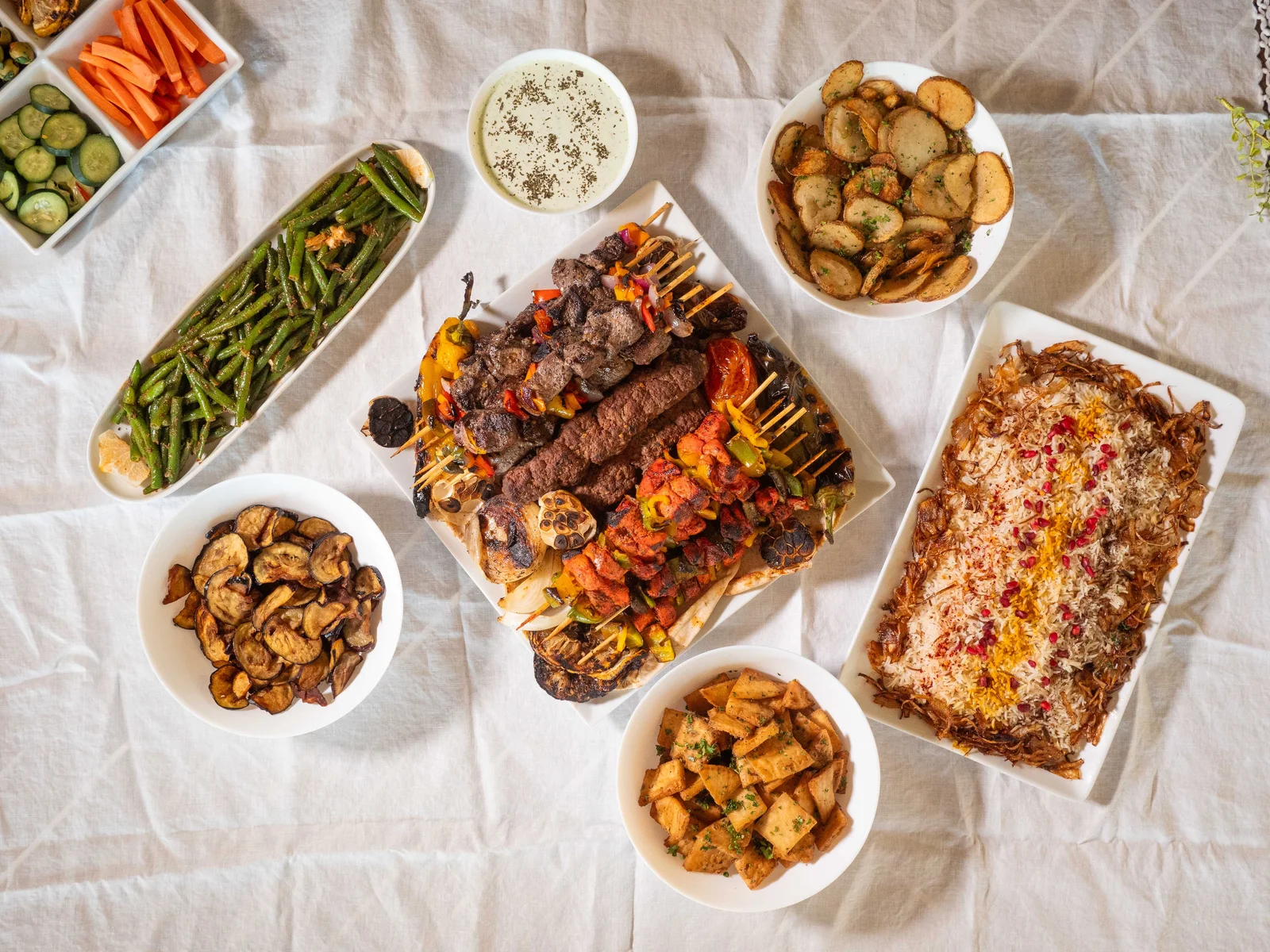 Mediterranean kebab platter with grilled meats, rice, tzatziki, and sides for wedding catering